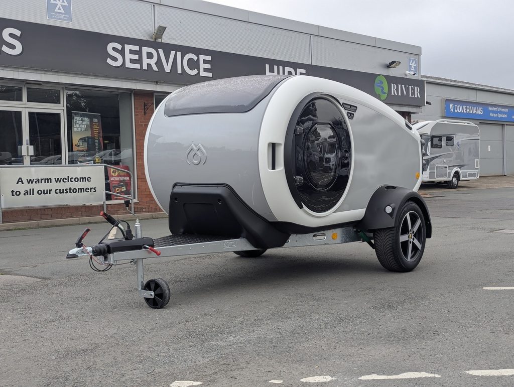 A MINK-Z MINK camper model parked outside of the River Motorhomes showroom entrance in Sutton Coldfield.